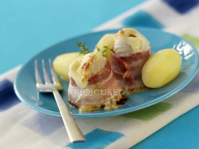 Fish fillets wrapped in bacon — Stock Photo