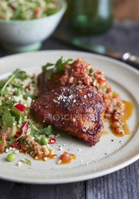 Closeup view of barbecued chicken with Salbitxada and couscous — Stock Photo