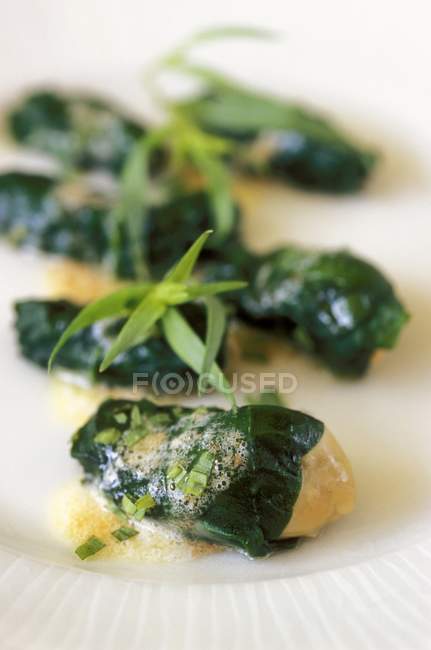 Oysters wrapped in spinach — Stock Photo