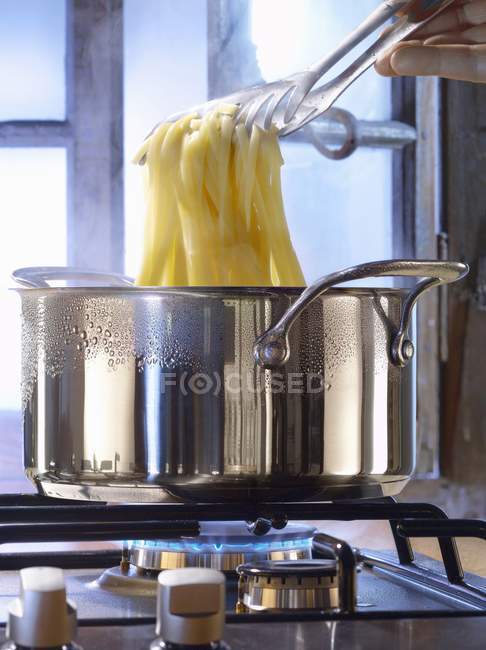 Cocinar pasta en una cacerola - foto de stock