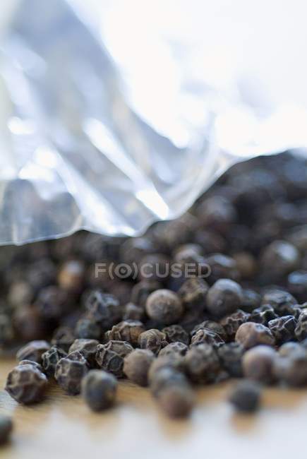 Peppercorns spilling out — Stock Photo