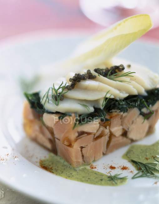 Fish terrine with scallops  on white plate — Stock Photo