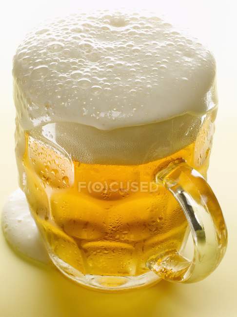 Pint of lager on white background — Stock Photo