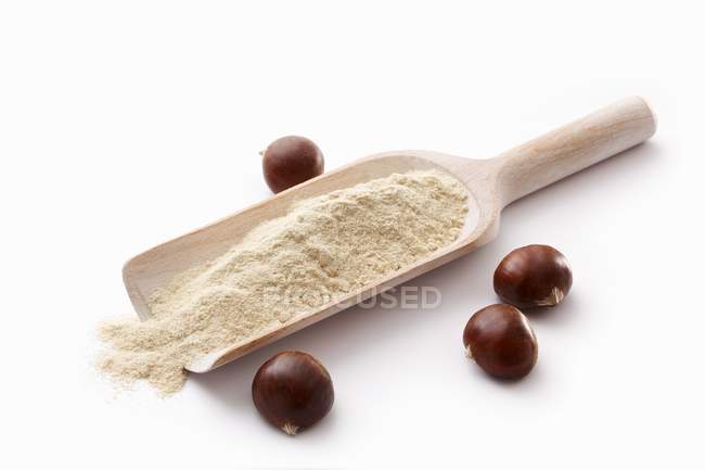 Chestnut flour on wooden scoop — Stock Photo