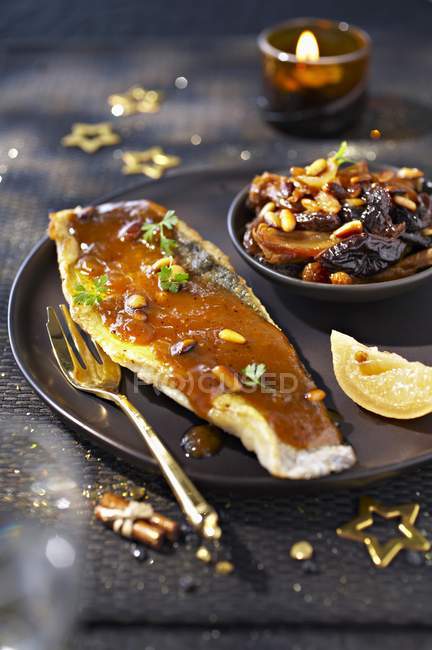 Bass fillet with dried fruits — Stock Photo