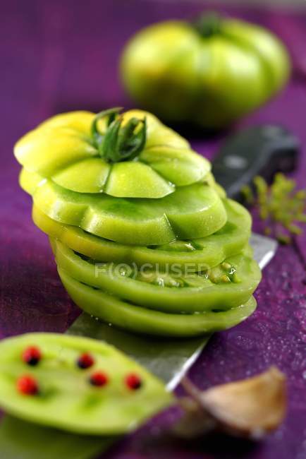 Slicing green tomato — Stock Photo