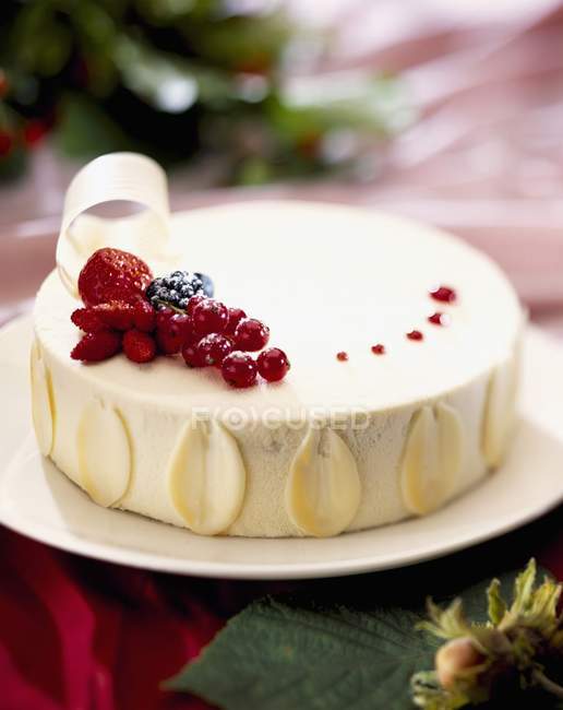 Coconut and summer fruit iced cake — Stock Photo