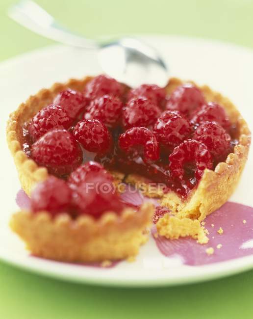 Closeup view of broken tarlet with raspberries — Stock Photo