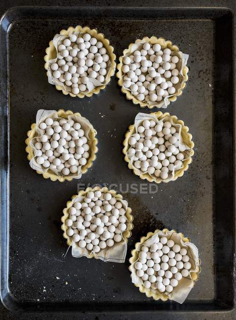 Tartlets on frying pan — Stock Photo