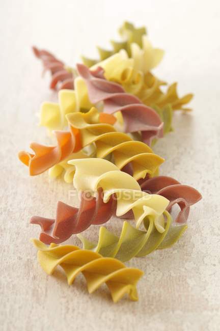 Uncooked colored fusilli pasta — Stock Photo