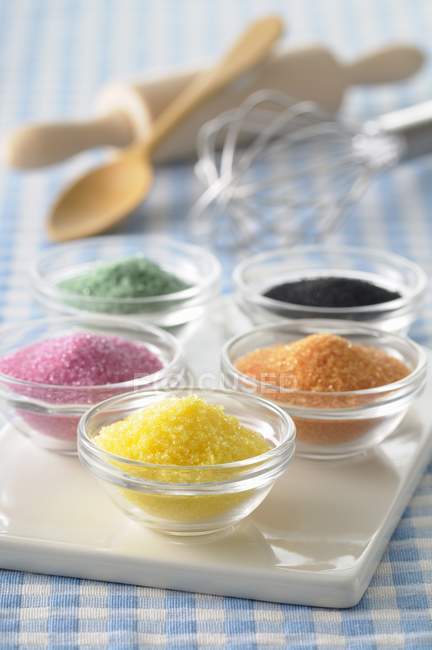 Bowls of different colored sugars — Stock Photo