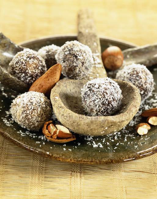 Closeup view of chocolate balls with nuts and coconut flakes — Stock Photo