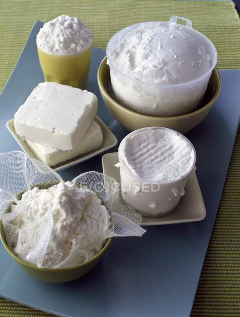 Fresh cheeses in bowls — Stock Photo