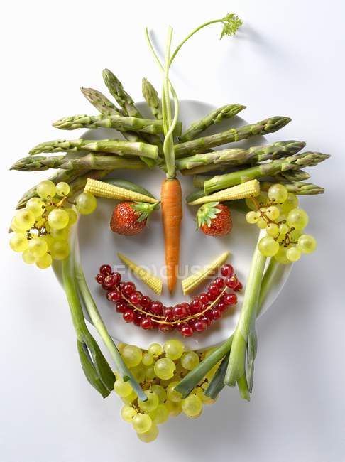 Fruit and vegetables in face shape — Stock Photo