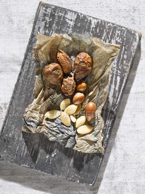 Closeup top view of Argan nuts on paper — Stock Photo