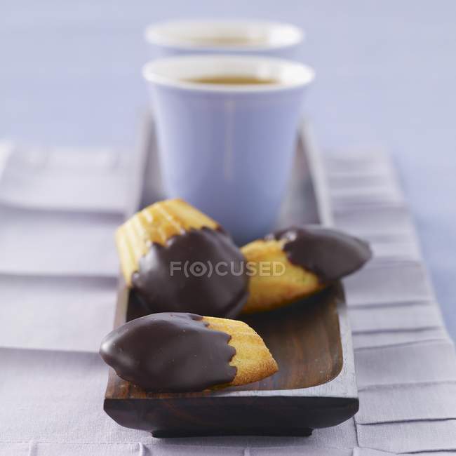 Madeleines half coated with chocolate — Stock Photo