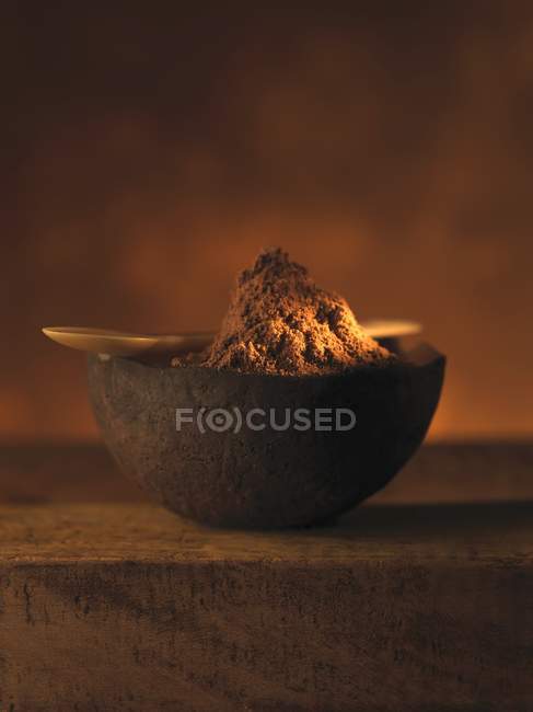 Closeup view of ground nutmeg with a spoon on a bowl — Stock Photo