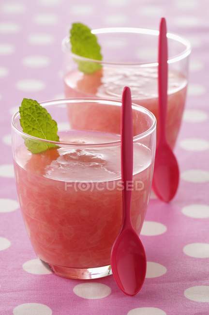 Rhubarb soup in glasses with red spoons — Stock Photo
