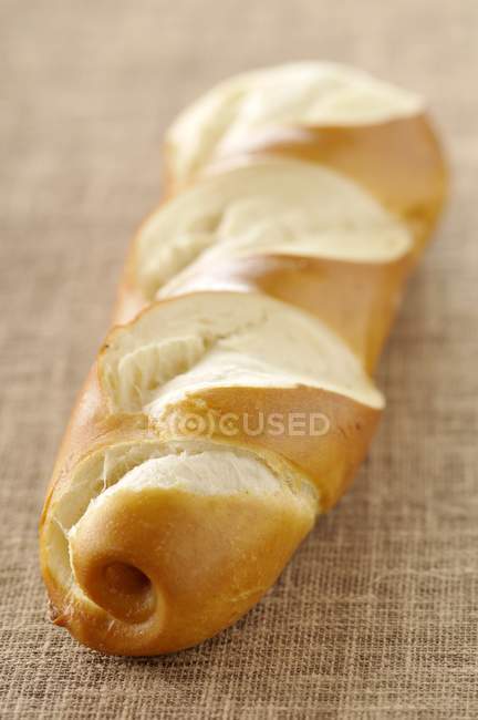 Closeup view of baguette-shaped Bretzel on cloth — Stock Photo