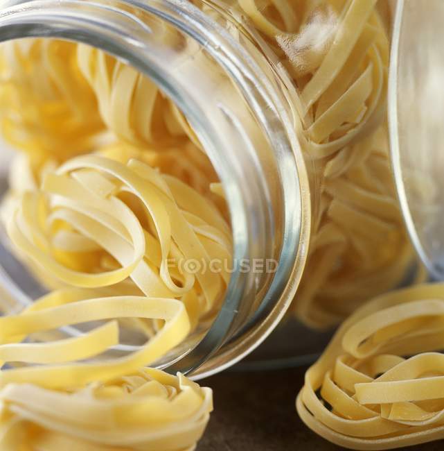 Dry uncooked linguine pasta — Stock Photo