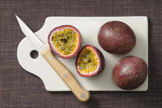 Whole and halved Passion fruits — Stock Photo
