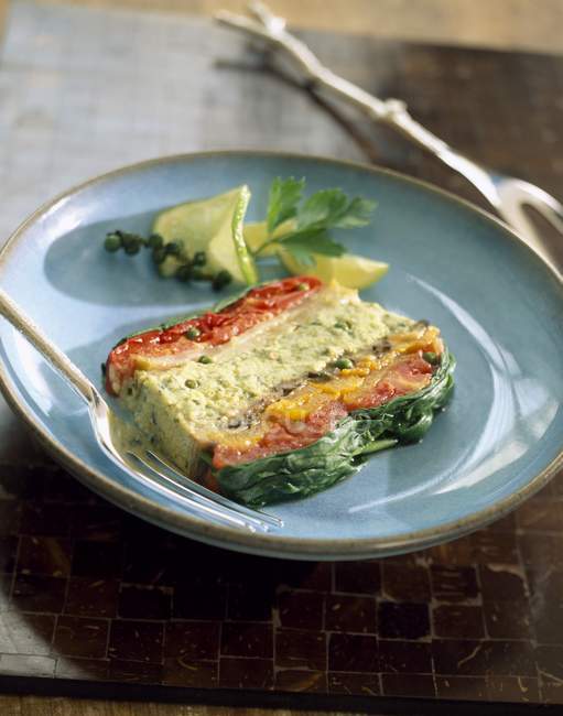 Terrine de légumes sur assiette verte avec fourchette — Photo de stock