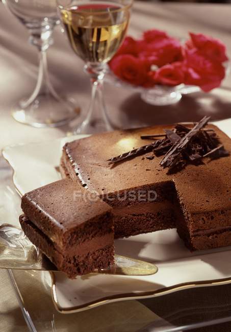 Closeup view of cut chocolate and hazelnut Caraque cake — Stock Photo