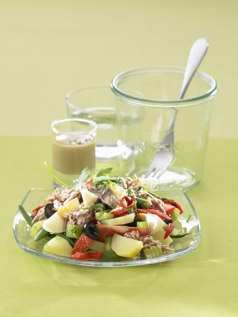 Nioise salad on glass plate — Stock Photo
