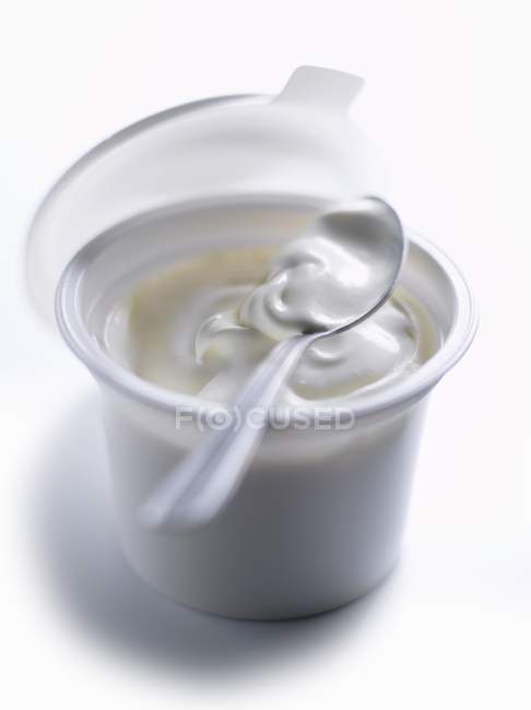 Closeup view of white bowl of Creme fraiche with spoon — Stock Photo