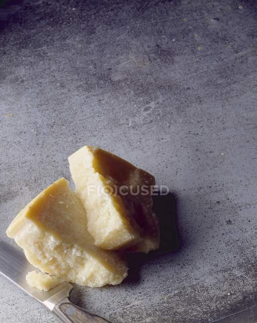 Parmesan on grey surface — Stock Photo