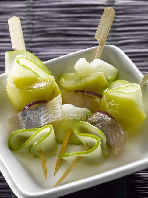 Apples in oil on plate — Stock Photo