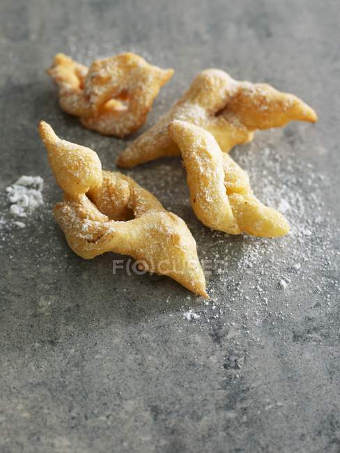 Closeup view of Merveilles with icing sugar on stone surface — Stock Photo