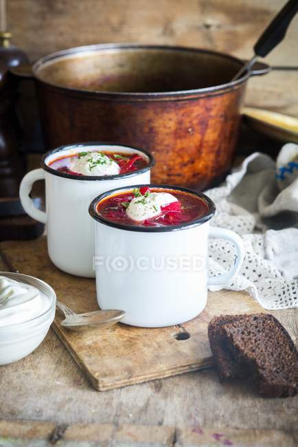 Borscht - Sopa tradicional rusa y ucraniana de remolacha en tazas - foto de stock