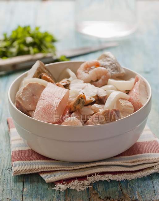 Bowl of mixed raw fish — Stock Photo