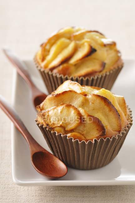 Two apple muffins with wooden spoons — Stock Photo