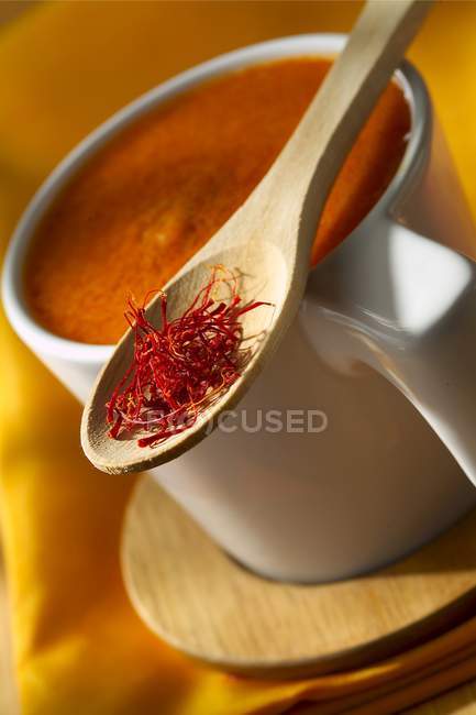 Rouille sauce in white cup over small desk — Stock Photo