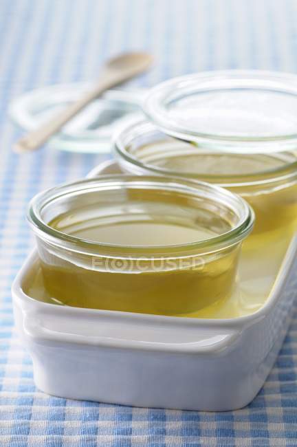 Bowls of apple jelly over tablecloth — Stock Photo