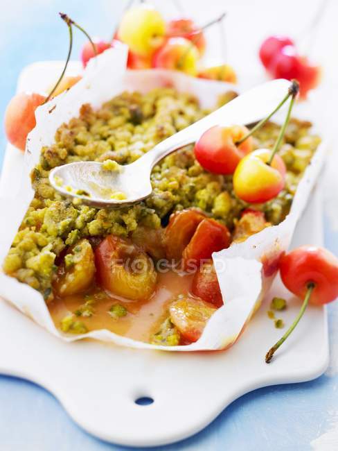 Closeup view of cherry crumble and spoon — Stock Photo
