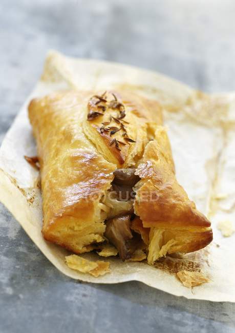 Oyster mushrooms in flaky pastry on paper — Stock Photo