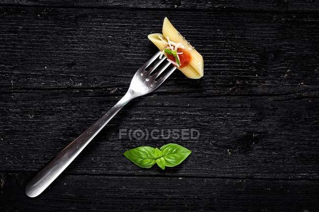Italian penne pasta with tomato and basil — Stock Photo