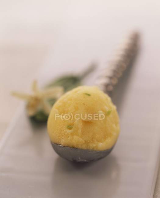Scoop of pineapple sorbet — Stock Photo