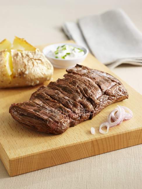 Grilled sirloin steak with baked potato — Stock Photo