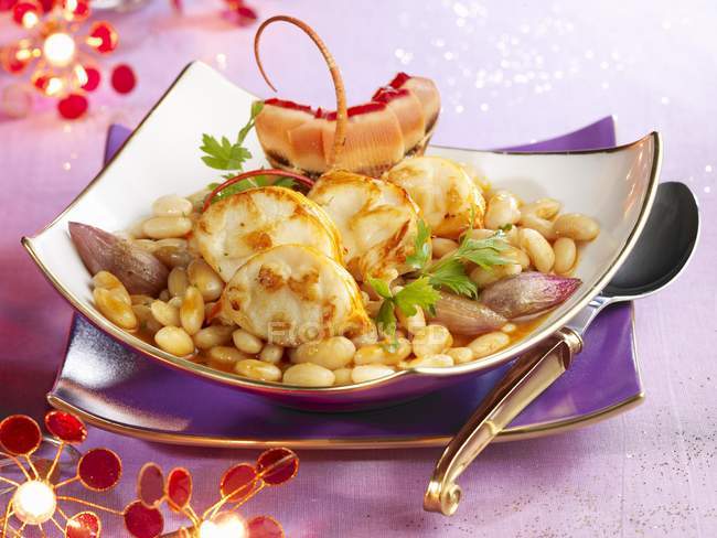 Spiny lobster Cassoulet with shallots on square plate with spoon — Stock Photo