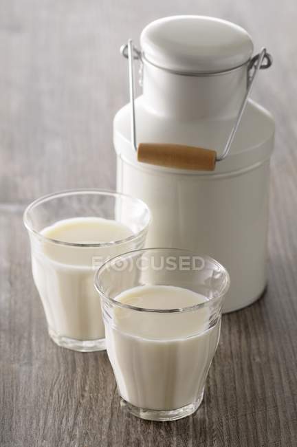 Milk jug and two glasses — Stock Photo