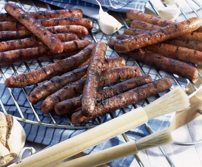 Grilled sausages on rack — Stock Photo