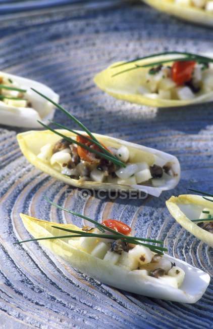 Chicory boats with scallops — Stock Photo