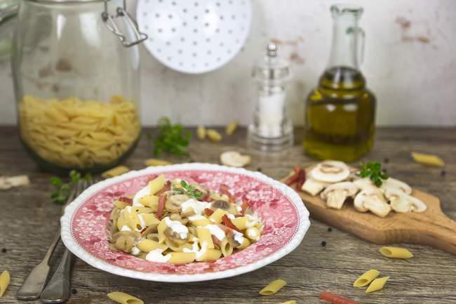 Penne pasta with cream, bacon and mushrooms — Stock Photo