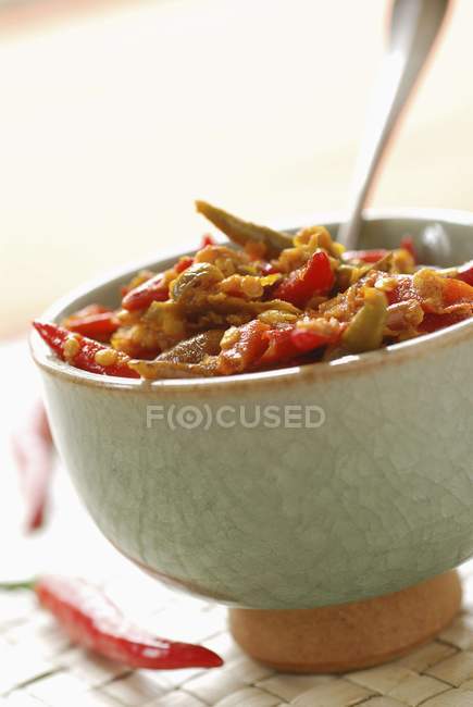 Hot pepper achard in white bowl over table — Stock Photo