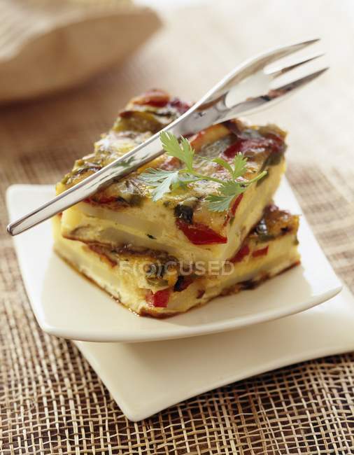 Southern tortilla on white small platter with fork — Stock Photo