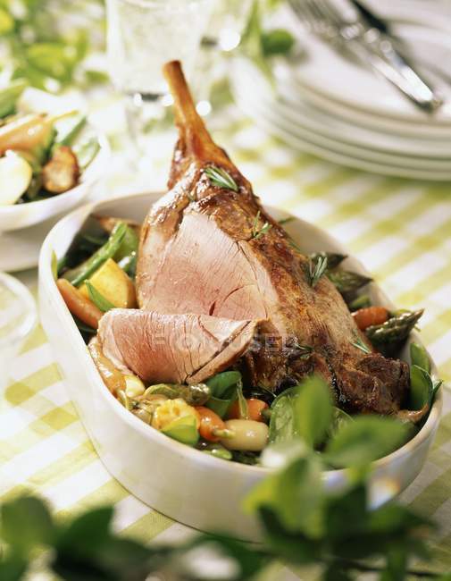 Leg of lamb with spring vegetables — Stock Photo